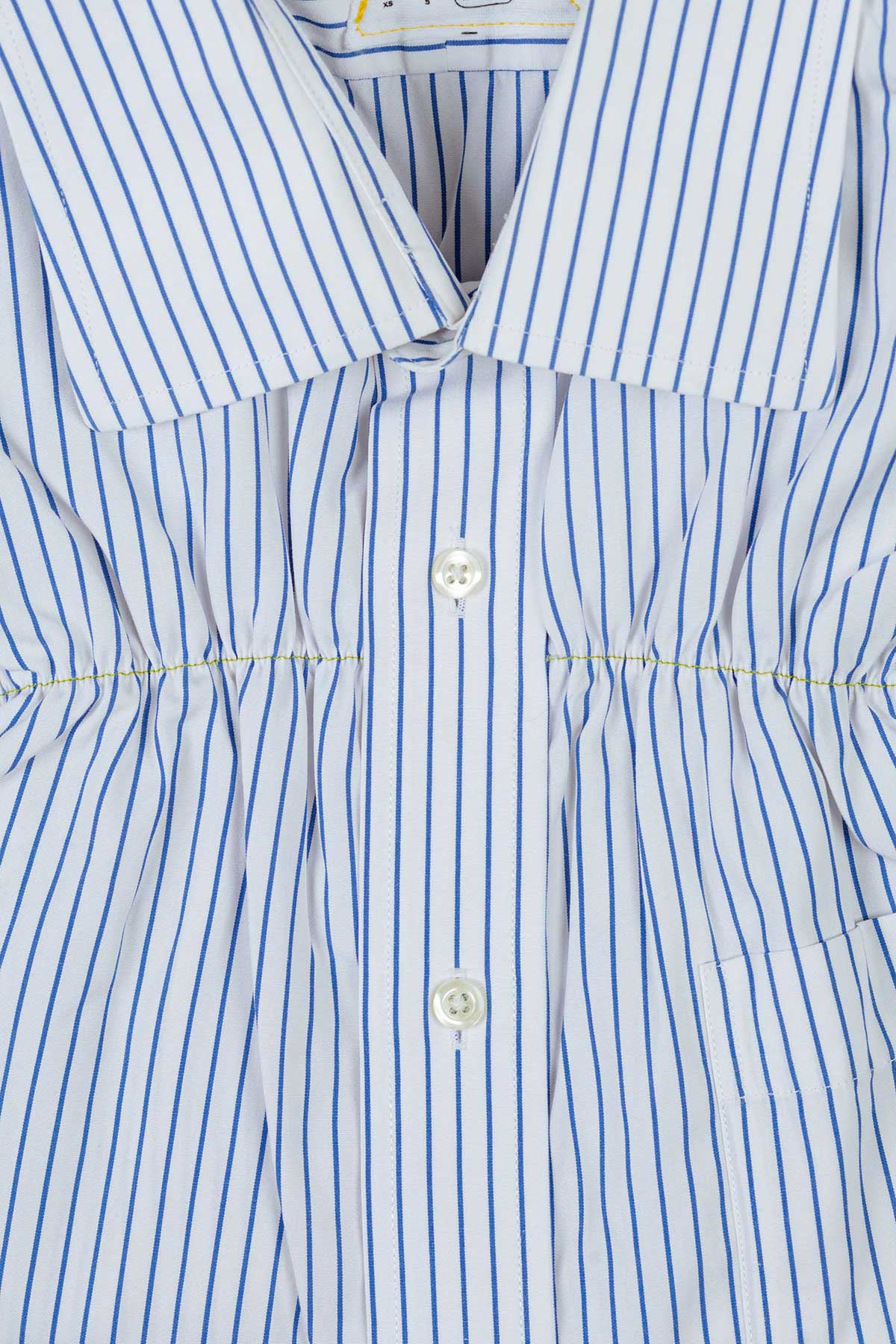 blue and white striped shirt with yellow topstitching ruching detail