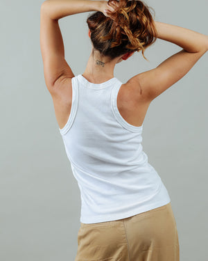 woman wearing the 90s tank in white from the back with tattoo on her neck