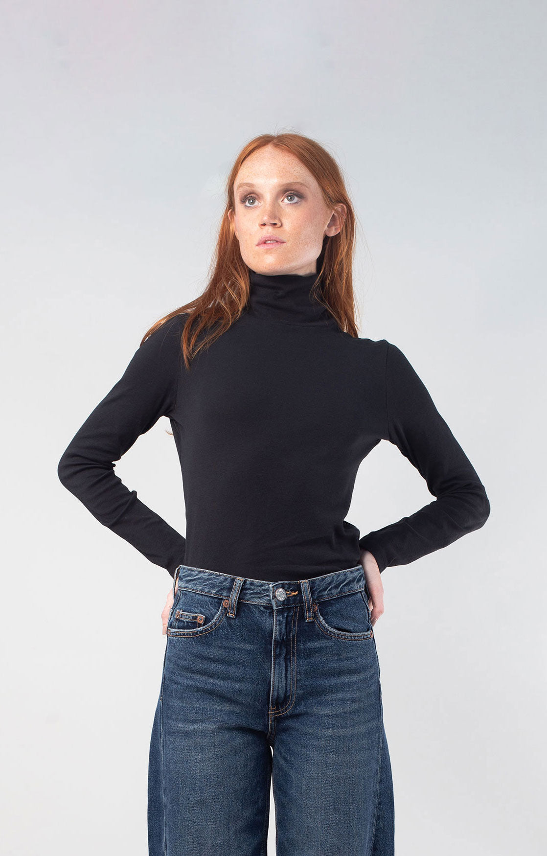 Woman with red hair wearing the Black organic turtleneck 