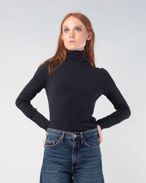 Woman with red hair wearing the Black organic turtleneck 