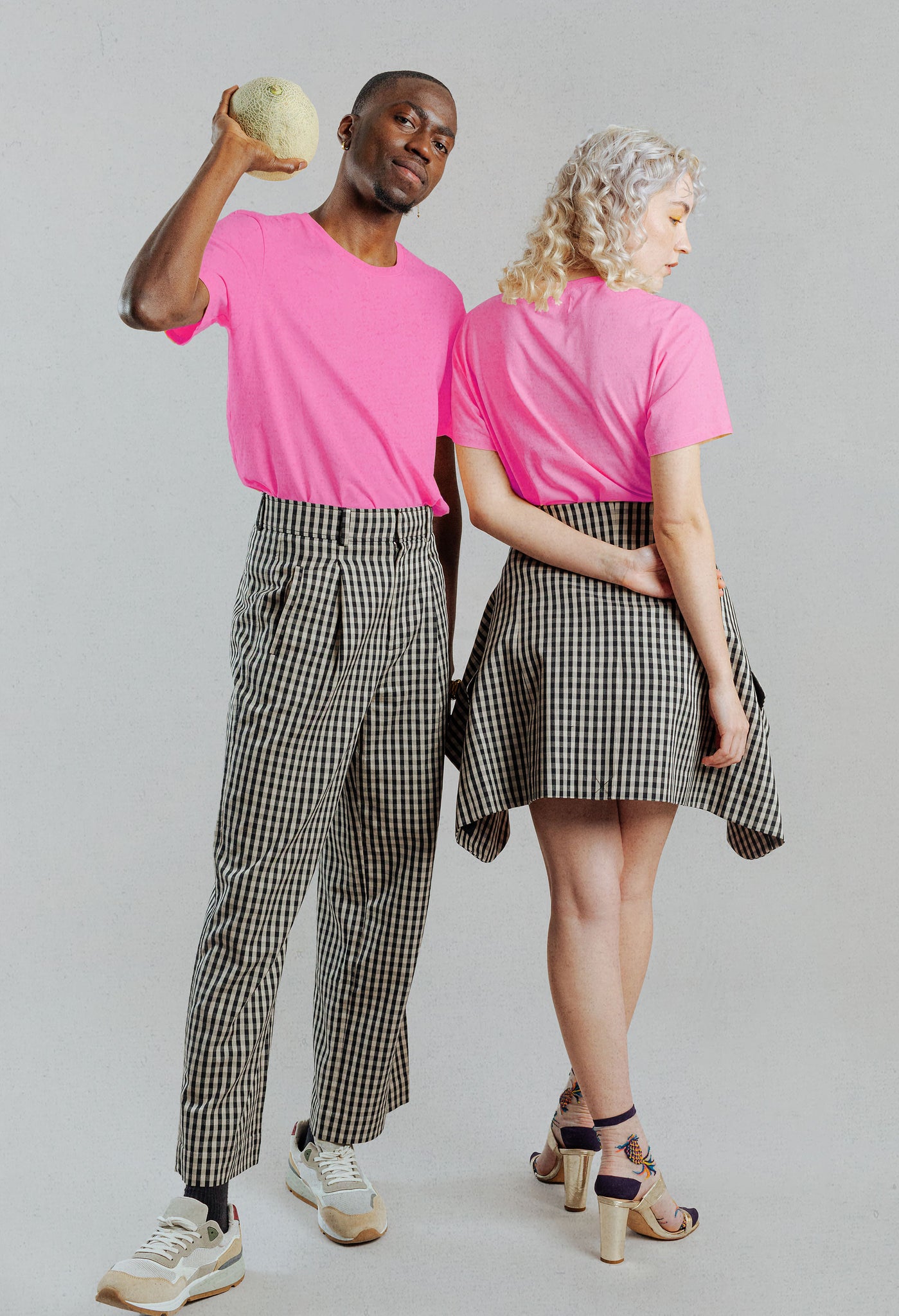 a man and woman wearing the naturally dyed better barbie hot pink t-shirt
