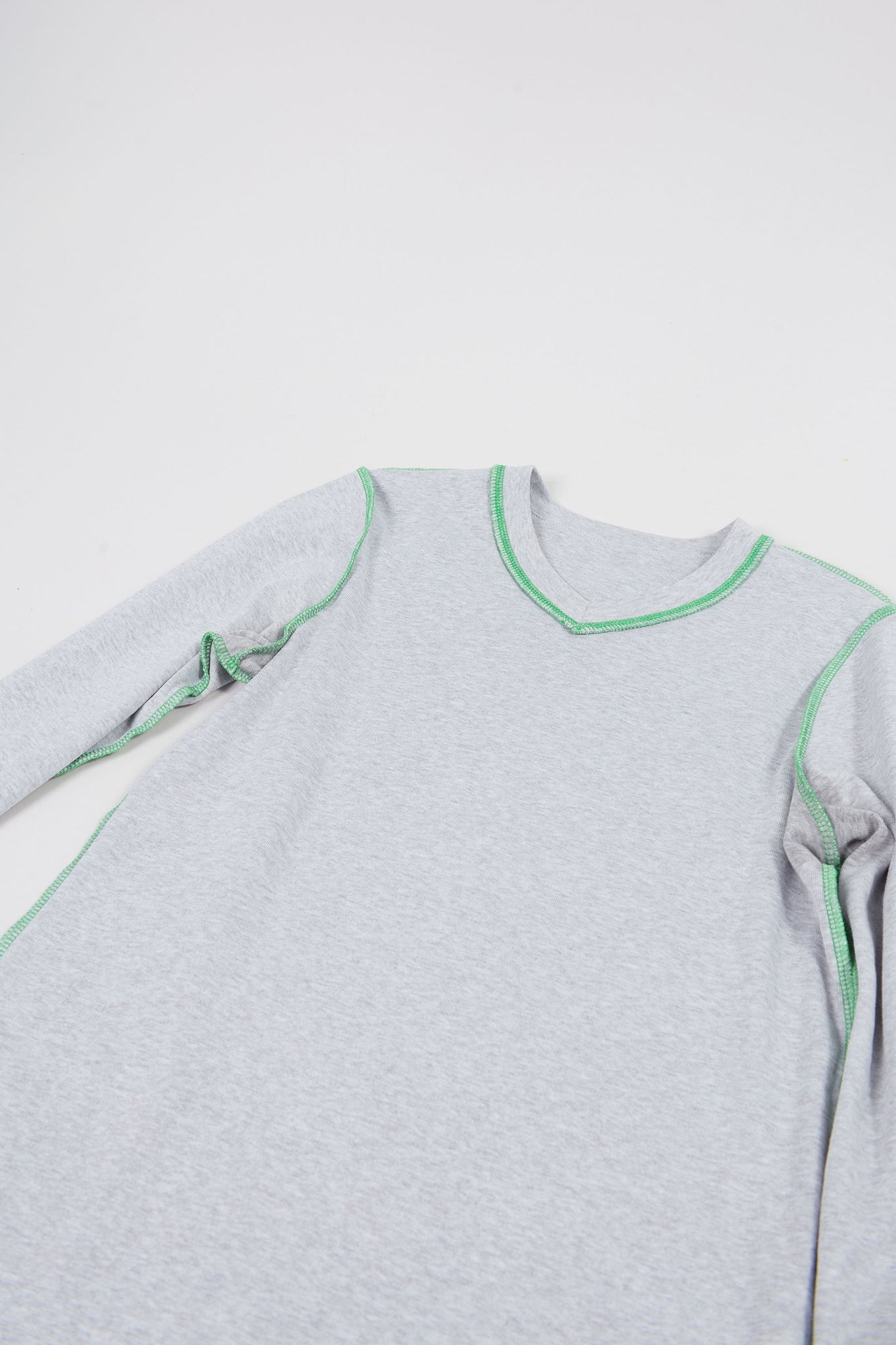lay down of the heather grey micro vneck long sleeve tee reversed with pop color interior stitching in green