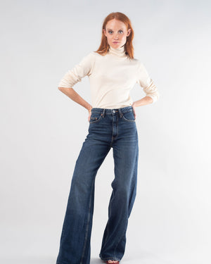 woman with red hair wearing the undyed turtleneck posing with arms on her hips
